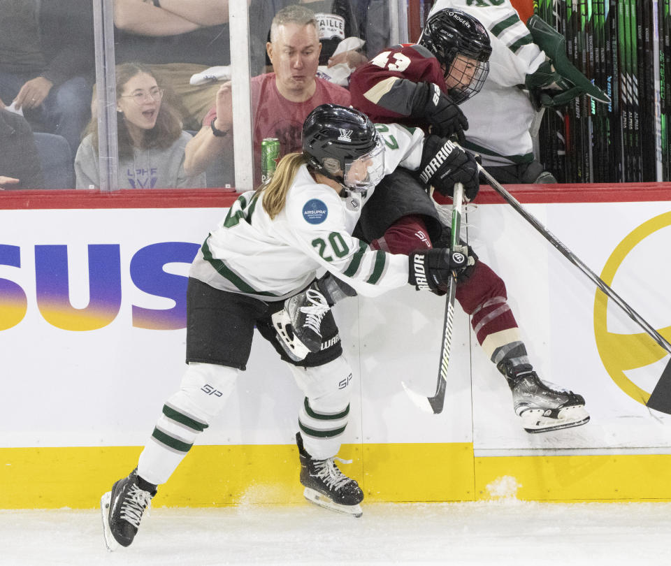 Montreal's Kristin O'Neill (43) is checked into the boards by Boston's Hannah Brandt (20) during second-period PWHL playoff hockey game action in Laval, Quebec, Saturday, May 11, 2024. (Christinne Muschi/The Canadian Press via AP)