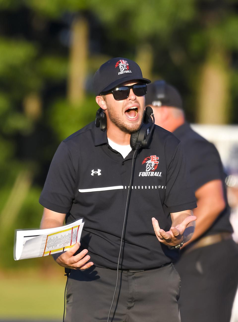Trojan head coach Jake Meiners reacts during the Skyline Chili Crosstown Showdown against Lawrenceburg at East Central High School on Friday, Aug. 19, 2022.