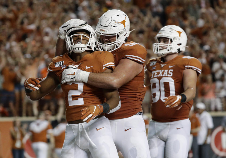 Texas' Roschon Johnson (2) celebrates his touchdown run with teammates during the second half of an NCAA college football game against Oklahoma State, Saturday, Sept. 21, 2019, in Austin, Texas. (AP Photo/Eric Gay)