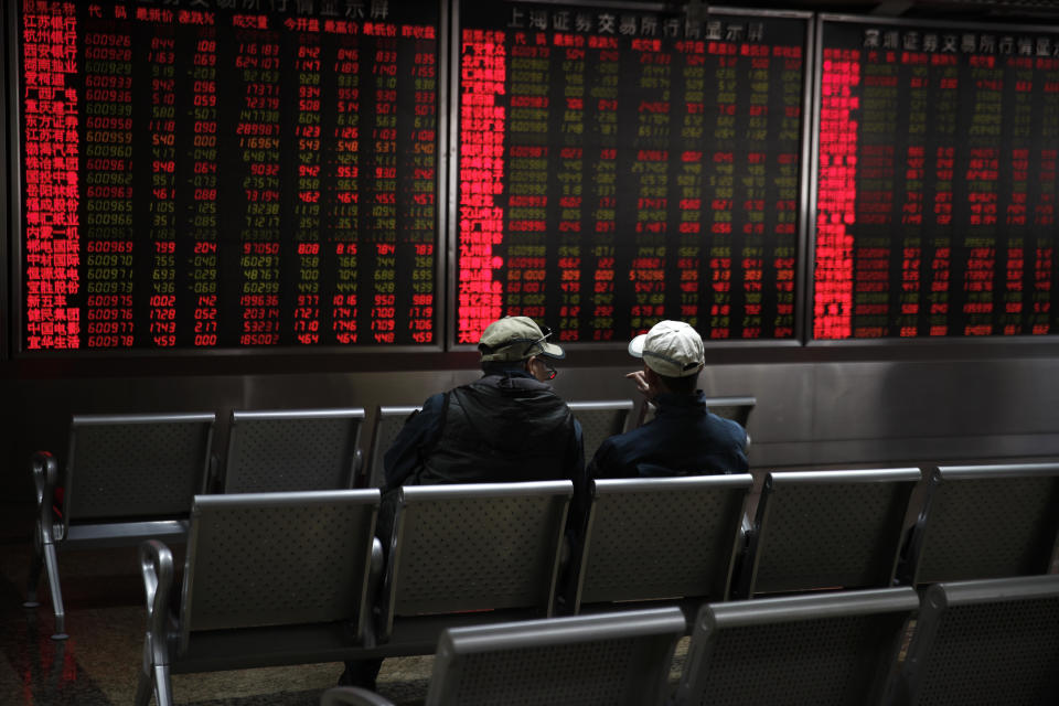 Investors chat as they monitor shares prices at a quiet brokerage house in Beijing, Wednesday, March 27, 2019. Shares were mixed in Asia early Wednesday after U.S. stocks finished broadly higher on Wall Street, erasing modest losses from a day earlier.(AP Photo/Andy Wong)