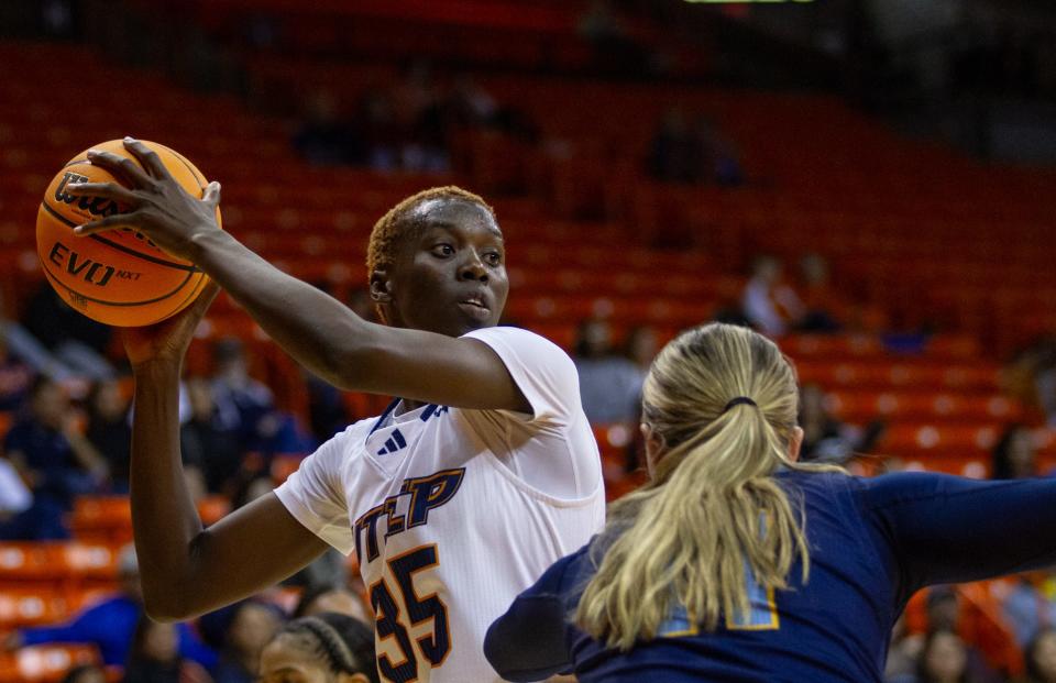 UTEP's Jane Asinde (35) looks to make a pass against a UMKC defender at the Don Haskins center on Nov. 11, 2023.