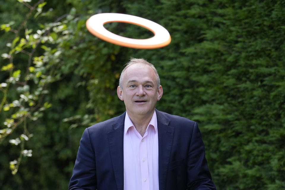 Liberal Democrats leader Ed Davey plays a game of frisbee during a visit to Crowd Hill Farm, in Hampshire, England, while on the General Election campaign trail, Tuesday June 18, 2024. (Andrew Matthews/PA via AP)