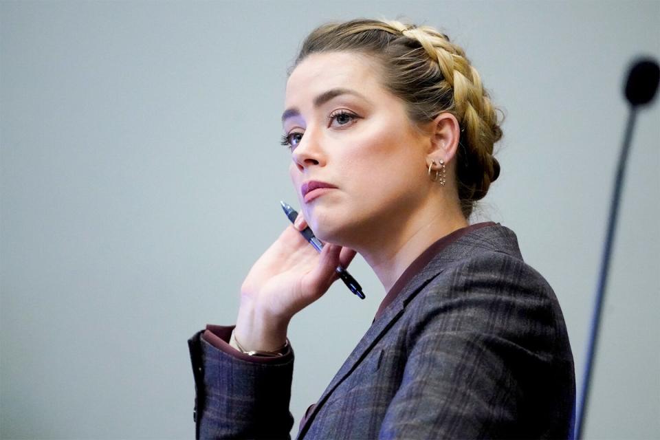 Amber Heard listens in the courtroom at the Fairfax County Circuit Court in Fairfax, Virginia