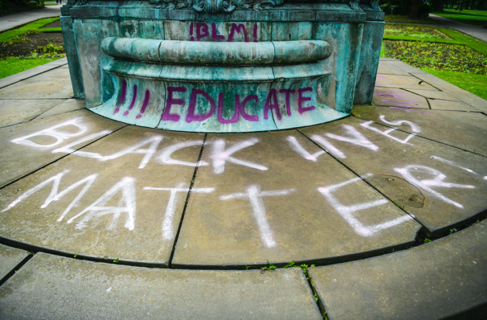 The statue was daubed with 'Black Lives Matter' and 'educate'. (SWNS)