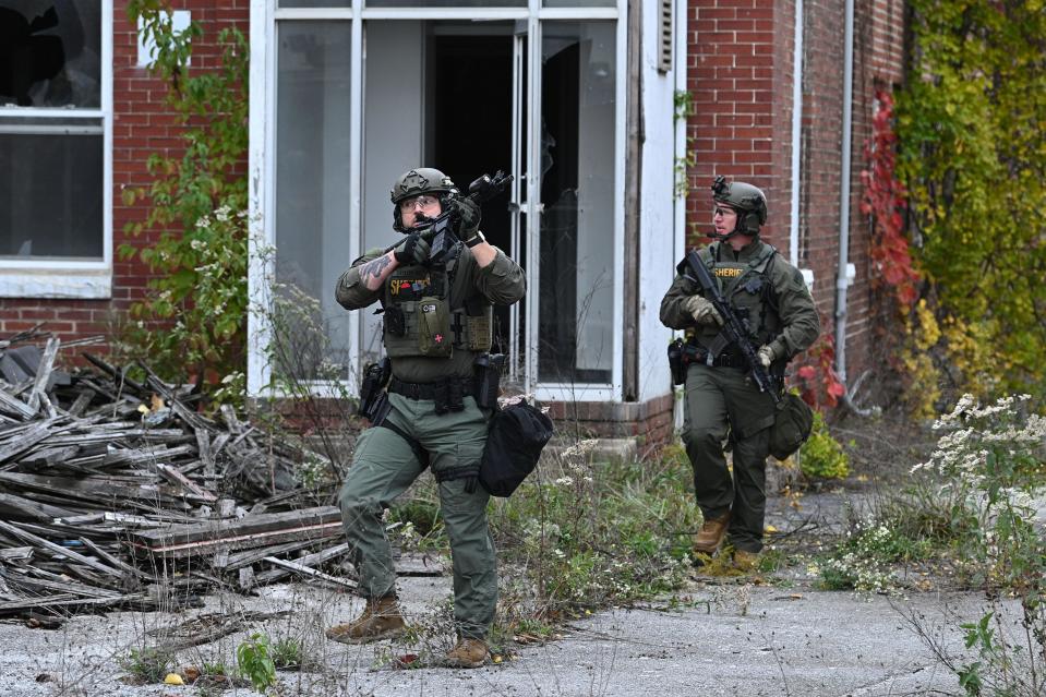 Officers with the Frederick County Sheriff's SWAT Team search Saturday for murder suspect Pedro Argote at the former Garden State Tannery plant property near Williamsport. Argote is the suspect in the killing of Washington County Circuit Court Judge Andrew Wilkinson. Argote's SUV was found in the area that morning.