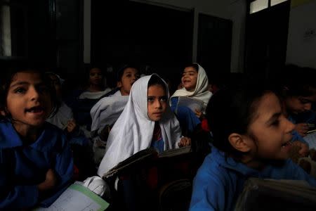 A girl attends her daily class with others at a government school in Peshawar October 29, 2014. REUTERS/Fayaz Aziz