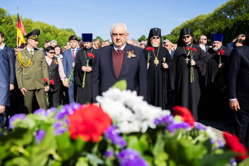 Sergei Yuryevich Nechayev (C), Ambassador of the Russian Federation to Germany, stands in front of memorial wreaths at the Soviet War Memorial in Treptow Park. May 8 and 9 marks the 79th anniversary of Nazi Germany's unconditional surrender in World War II (WWII). Christoph Soeder/dpa