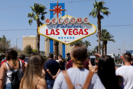 Tourists visit "The welcome to fabulous Las Vegas" sign in Las Vegas, Nevada, U.S., August 27, 2018. Picture taken August 27, 2018. REUTERS/Mike Blake