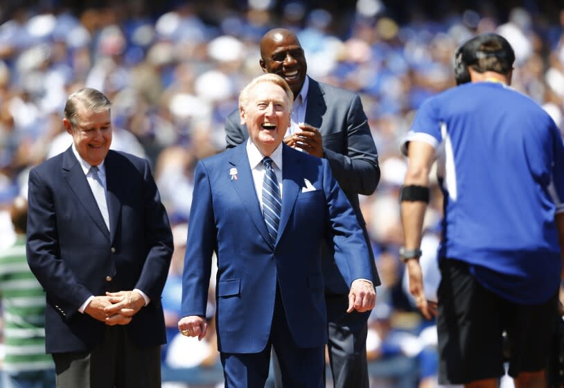 LOS ANGELES, CA - APRIL 12, 2016: Dodgers announcer Vin Scully is honored at home plate on his last Opening Day on April 12, 2016 at Dodger Stadium in Los Angeles, California. Former Dodgers owner Peter O'Malley is on the left and Magic Johnson is on the right.(Gina Ferazzi / Los Angeles Times)