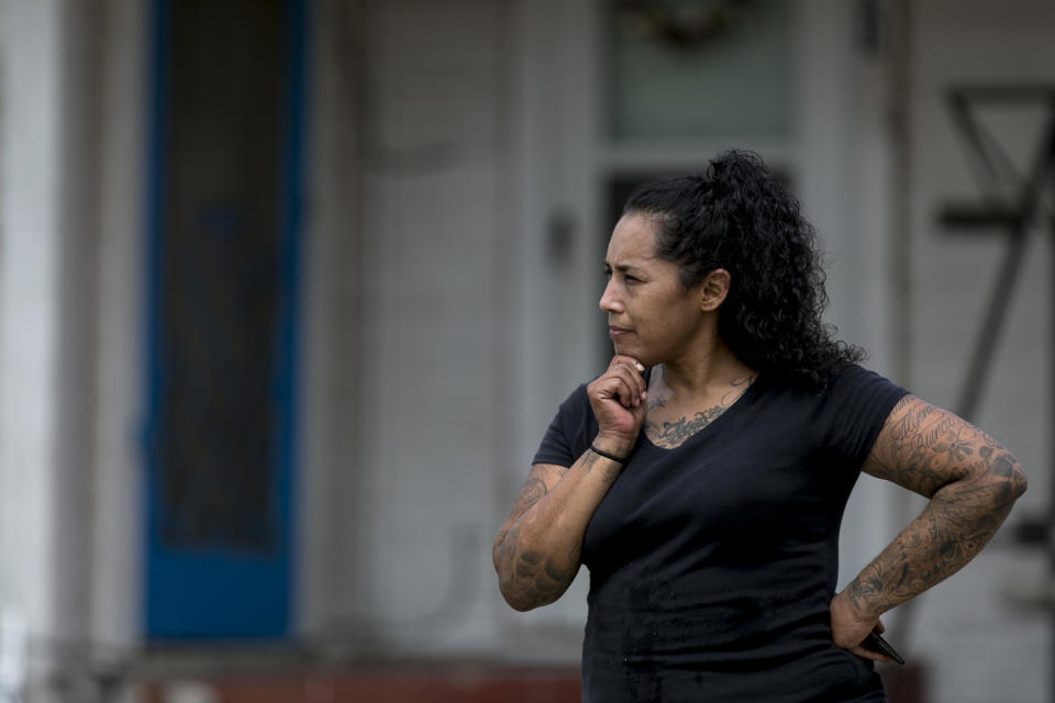 Sandra Cerna watches the removal of over 100 snakes from a home in the 500 block of Kayton Avenua on San Antonio's Southside, Wednesday, Sept. 5, 2018. Cerna lives a few doors down from the home that the snakes were removed from and said she never suspected anything. "We're always through here and never did we think anything like this was going on... it's crazy." She said. (Josie Norris /The San Antonio Express-News via AP)