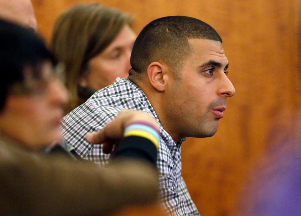 Dennis Hernandez, brother of former New England Patriots player Aaron Hernandez, watches during his brother's murder trial in 2015. Former UConn football player is behind bars after a witness told police she believed he was planning a school shooting.