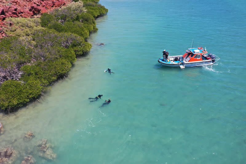Aerial photo shows divers from Deep History of Sea Country searching for artefacts off Dampier Archipelago in Western Australia