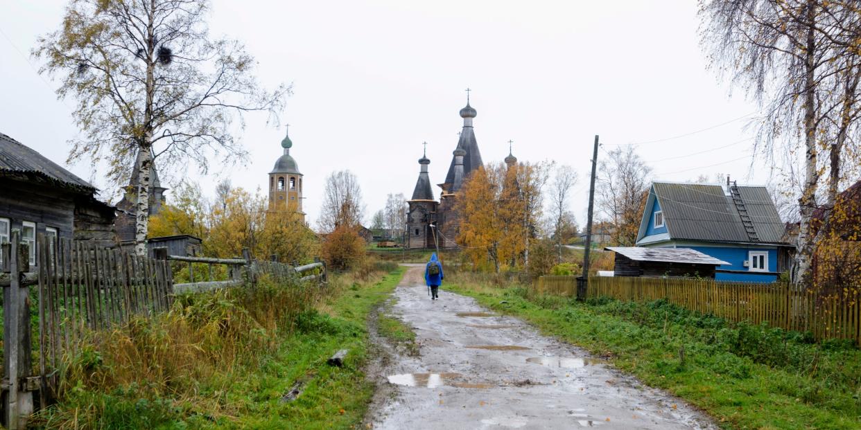 In this photo taken Oct. 7, 2018, a person walks down a street in the village of Nyonoksa, northwestern Russia.