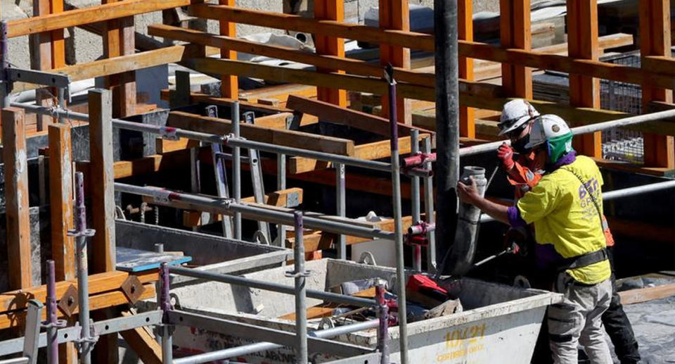 Two tradesmen working on a construction site