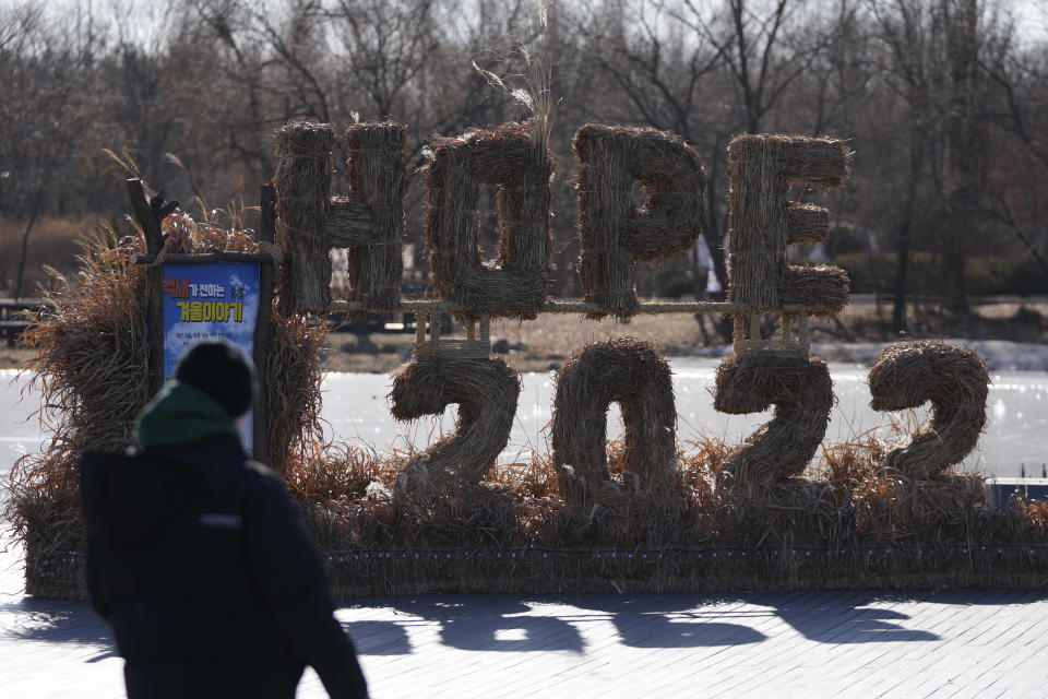 A man looks at the decorations for the coming 2022 Year on New Year's Eve in Seoul, South Korea, Friday, Dec. 31, 2021. (AP Photo/Lee Jin-man)