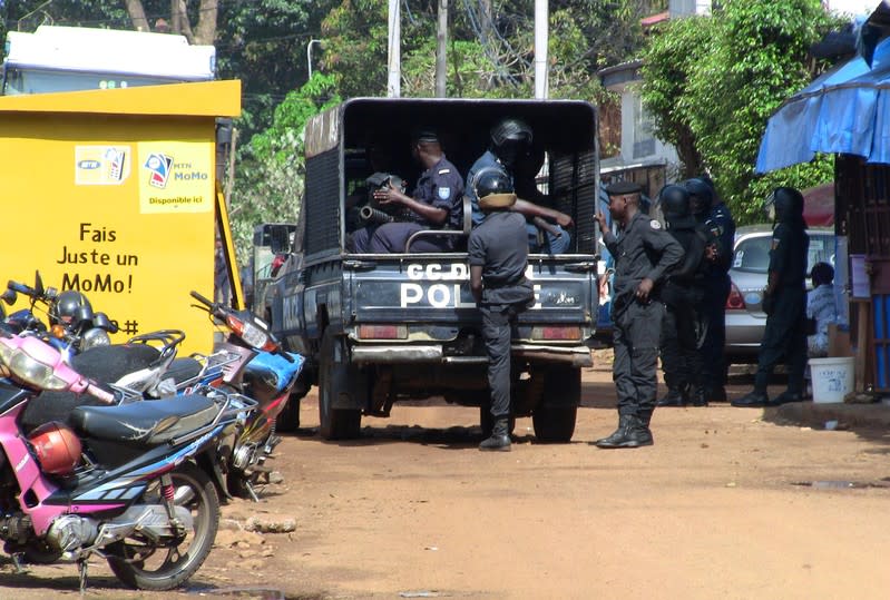 Police officers deploy outside a court in Conakry