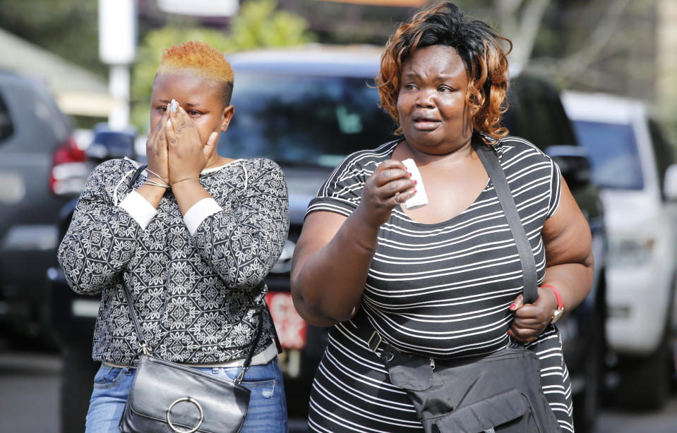 Women react after learning of a family member killed during a recent terrorist attack Wednesday, Jan. 16 2019, at the Chiromo Mortuary, Nairobi, Kenya. An upscale hotel complex in Kenya's capital came under attack on Tuesday, with a blast and heavy gunfire. The al-Shabab extremist group based in neighboring Somalia claimed responsibility and said its members were still fighting inside (AP Photo/Brian Inganga)