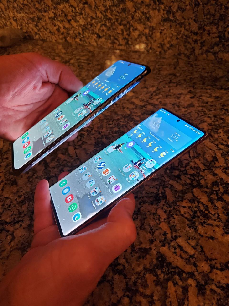 The Samsung Note20 Ultra (to the left below), compared to the Samsung S20 Ultra smartphone. The Note20 phablet is larger, but thinner and lighter than the smartphone.