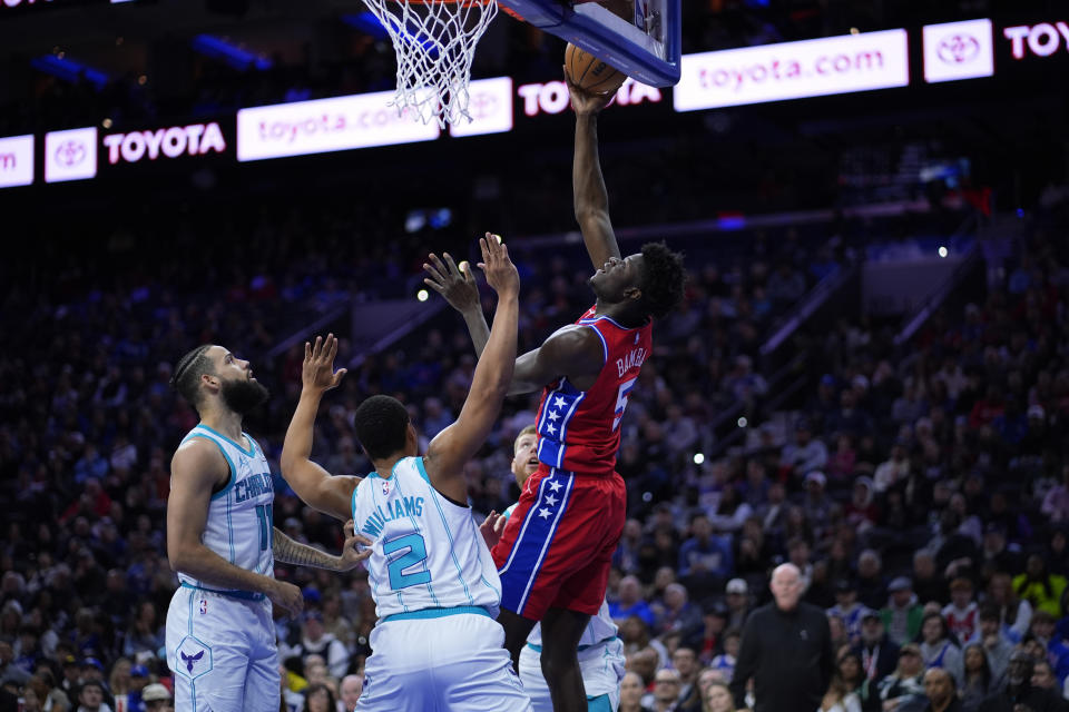 Philadelphia 76ers' Mo Bamba (5) goes up for a shot against Charlotte Hornets' Grant Williams (2) and Cody Martin (11) during the first half of an NBA basketball game, Friday, March 1, 2024, in Philadelphia. (AP Photo/Matt Slocum)