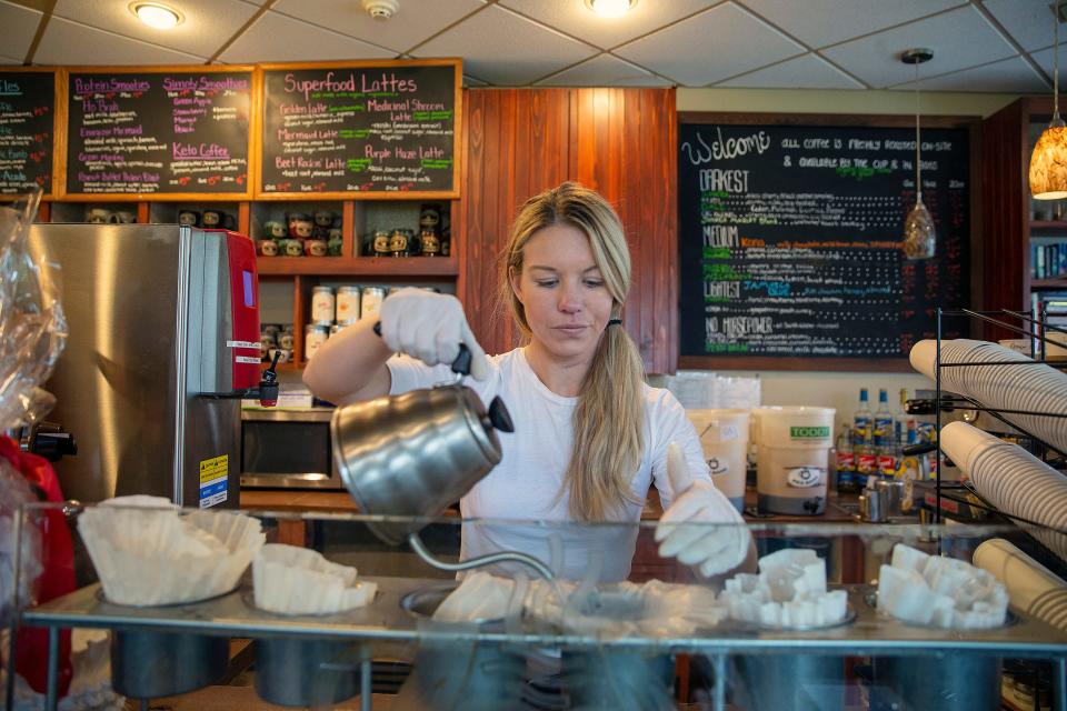 Owner Courtlyn Crosson prepares a coffee at Coffee Corral in Red Bank. Her favorite coffee drink is iced coffee with oat meal.