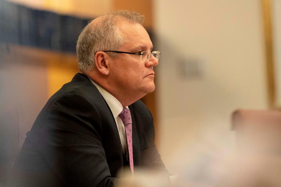 Australian Prime Minister Scott Morrison (C) attends a videoconference with G20 leaders to discuss the COVID-19 coronavirus, at the Parliament House in Canberra on March 26, 2020. - Leaders of the G20 major economies are holding an online summit on March 26, in a bid to fend off a coronavirus-triggered recession, after criticism the group has been slow to address the crisis. (Photo by Gary Ramage / POOL / AFP) (Photo by GARY RAMAGE/POOL/AFP via Getty Images)