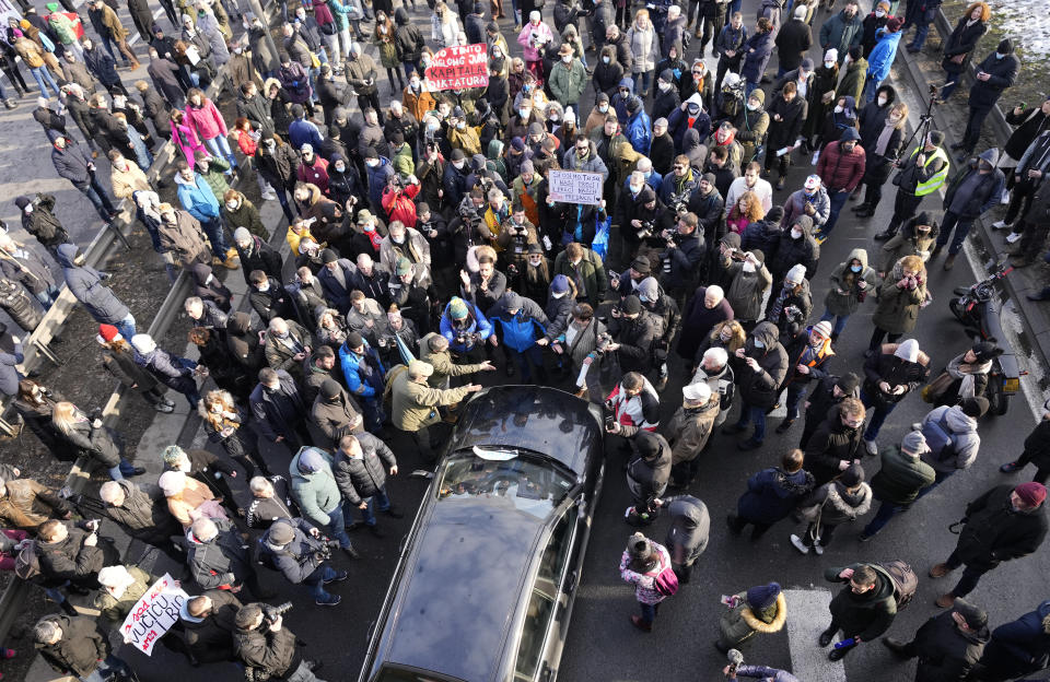 Environmental demonstrators block a highway, during a protest in Belgrade, Serbia, Saturday, Jan. 15, 2022. Hundreds of environmental protesters demanding cancelation of any plans for lithium mining in Serbia took to the streets again, blocking roads and, for the first time, a border crossing. Traffic on the main highway north-south highway was halted on Saturday for more than one hour, along with several other roads throughout the country, including one on the border with Bosnia. (AP Photo/Darko Vojinovic)