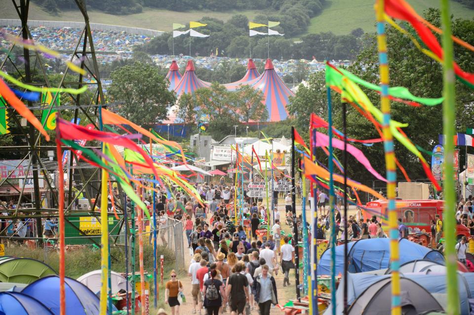 Festival goers walk towards the John Peel stage at Glastonbury music festival, England, Thursday, June 26, 2014. Thousands of music fans will attend this year to see headliners, Arcade Fire, Metallica and Kasabian. (Photo by Jonathan Short/Invision/AP)