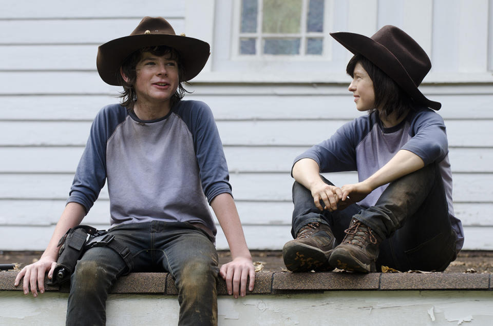 <p>Nope, it’s Chandler Riggs and his Carl Grimes stunt double, 32-year-old stuntwoman Emily Brobst.<br><br>(Photo: AMC) </p>