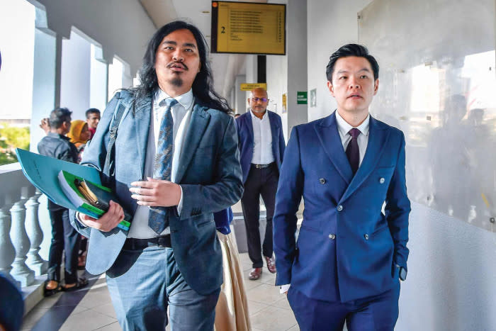 Producer Tan Meng Kheng with his counsel appearing in court