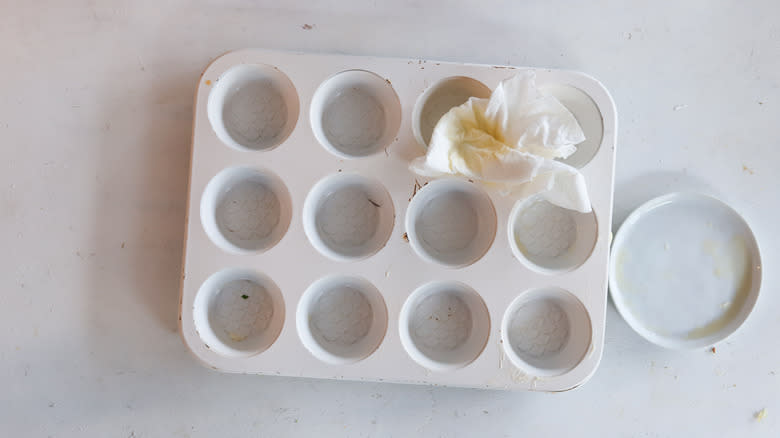 greased muffin tin with paper towel