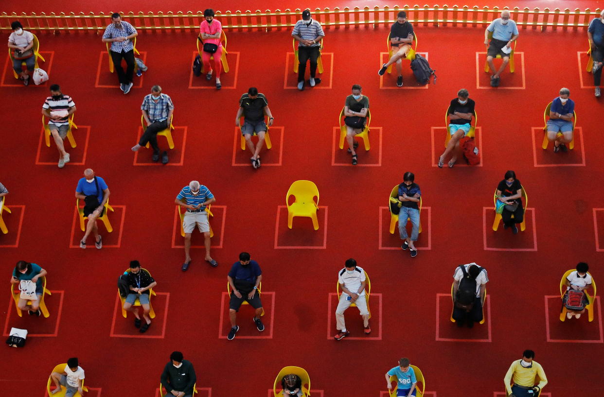 People watch an outdoor movie screening within their social distances during the coronavirus disease (COVID-19) outbreak in Singapore January 7, 2021. REUTERS/Edgar Su