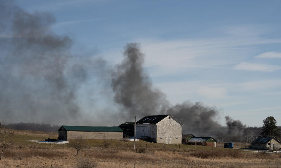 Smoke rises from a derailed cargo train in East Palestine, Ohio, on February 4, 2023. / Credit: DUSTIN FRANZ/AFP via Getty Images