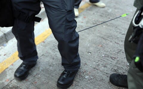 An officer was hit in the calf by an arrow fired by protesters outside the Polytechnic University of Hong Kong - Credit: EPA-EFE/REX/Hong Kong Police Force