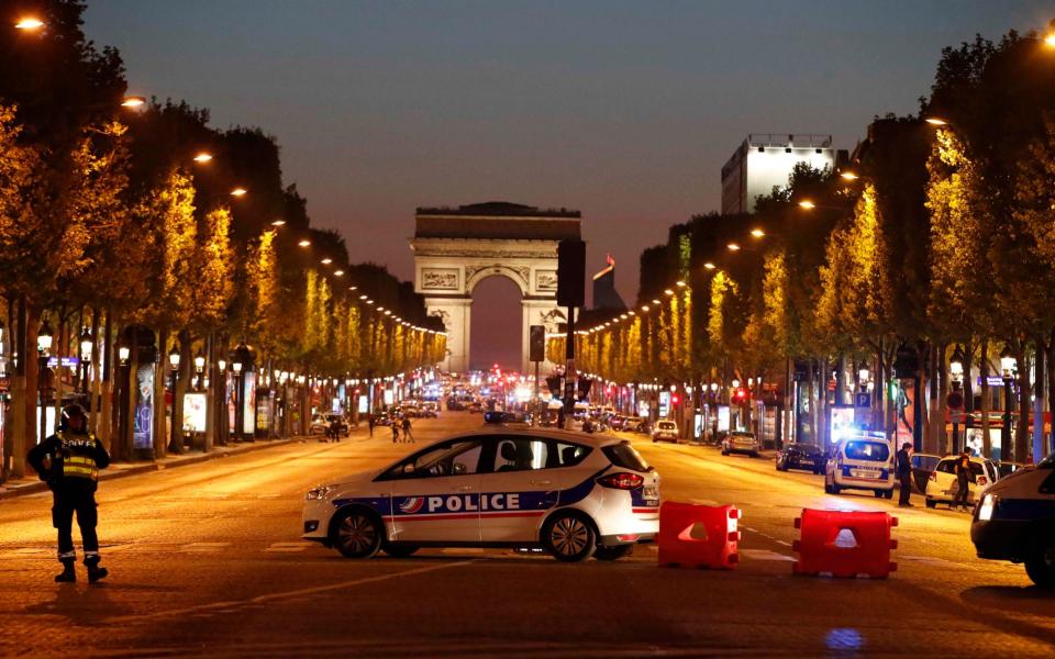 Police secure the Champs Elysee Avenue  - Credit: Reuters