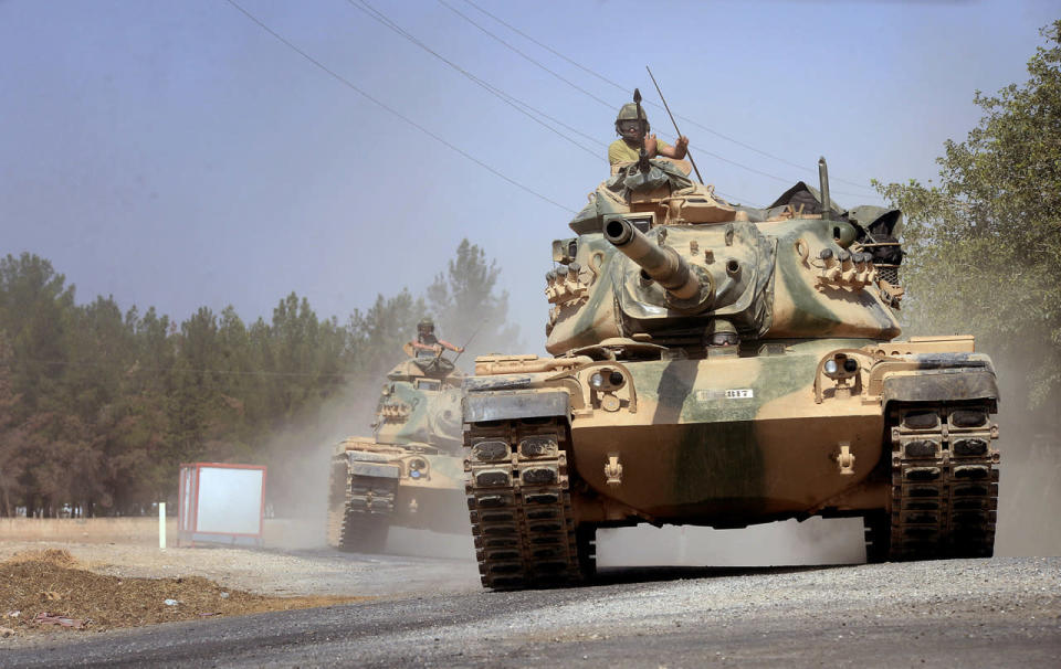 <p>Turkish tanks head towards the Syrian border, in Karkamis, Turkey, Aug. 31, 2016. Turkey on Wednesday dismissed reports of a cease-fire deal with Kurdish rebels in northern Syria, and vowed to continue its week-old military incursion into the neighboring country until all “terror entities are eliminated.” (Photo: Ismail Coskun, IHA/AP)</p>