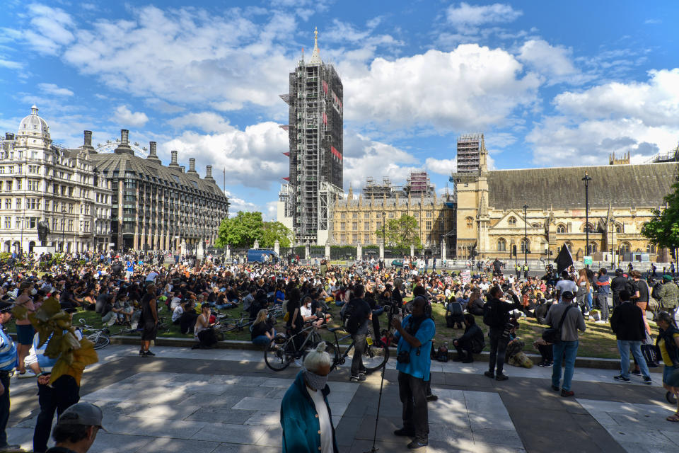 LONDON, UNITED KINGDOM - 2020/06/21: Black Lives Matter protesters sit in  front of the Houses of Parliament as activists give speeches during the demonstration. Black Lives Matter protests continue in the United Kingdom after the death of George Floyd killed by a police officer in Minneapolis. (Photo by Dave Rushen/SOPA Images/LightRocket via Getty Images)