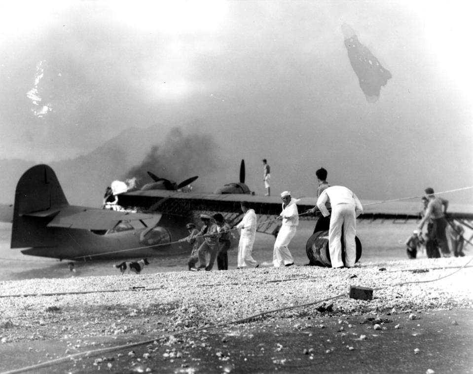 Sailors attemp to save a burning PBY amphibious aircraft
