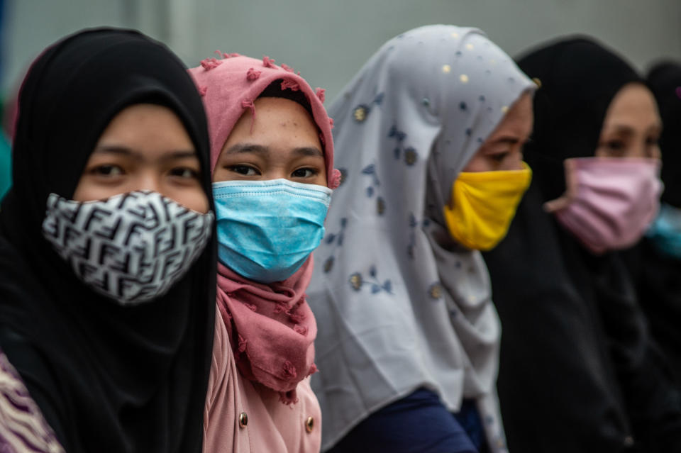 Filipino Muslims wear masks as a protective measure against the spread of covid-19 as they gather along the street outside the mosque during Eid'l Adha on July 31, 2020 in Manila, Philippines.(Photo by Lisa Marie David/NurPhoto via Getty Images)