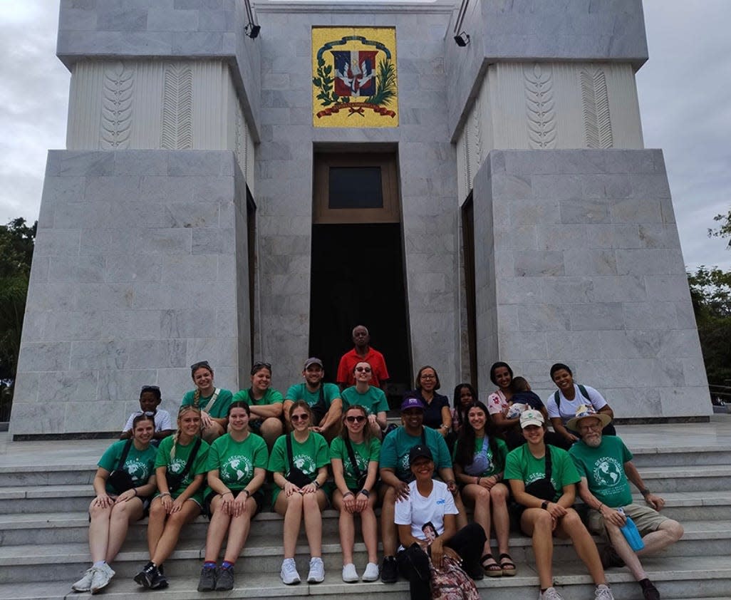 Mount Union students, along with some friends they met, gather in front a monument in Santo Domingo during their spring break trip to the Dominican Republic.