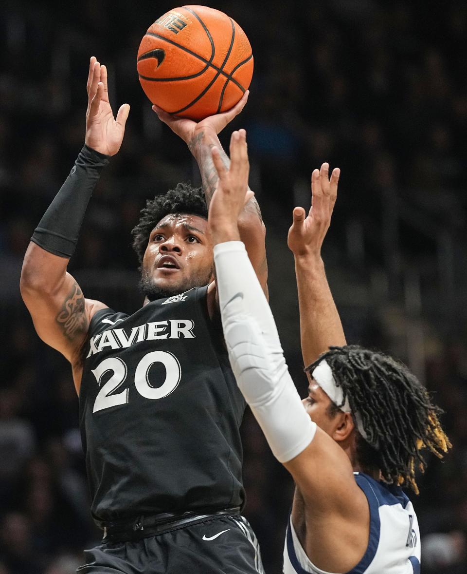 Xavier guard Dayvion McKnight shoots the ball over Butler's DJ Davis during the Bulldogs' 72-66 victory Wednesday night. Xavier fell to 15-15 and 9-10 in the Big East.