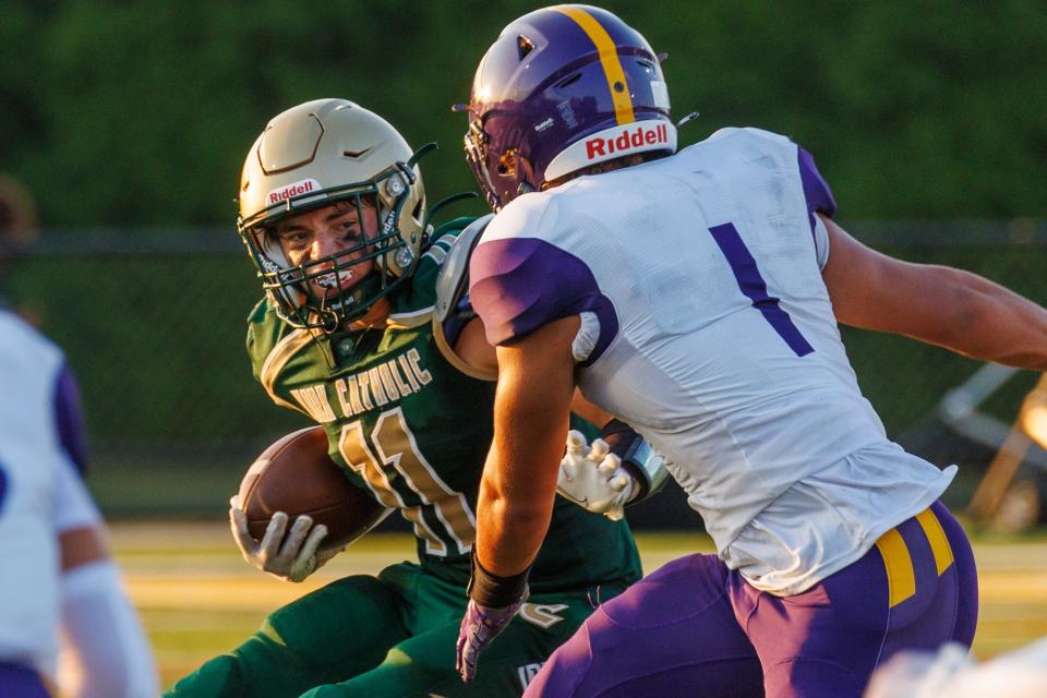 York Catholic's Evan Kipple (11) looks for an opening through the Lancaster Catholic defense during the first half of a football game between York Catholic and Lancaster Catholic, Friday, Aug. 25, 2023, at York Catholic. Lancaster Catholic led at the half 48-6.