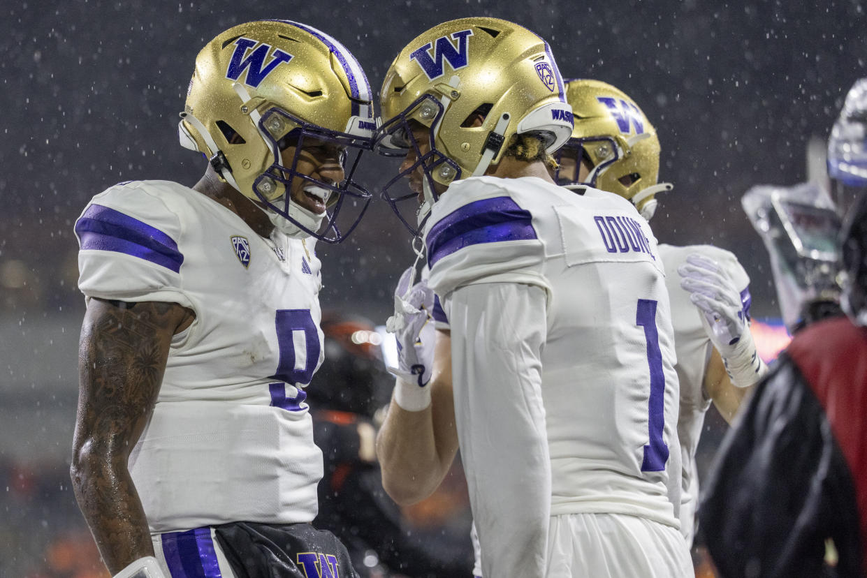 CORVALLIS, OREGON - NOVEMBER 18: Wide receiver Rome Odunze #1 of the Washington Huskies celebrates his touchdown catch with Michael Penix Jr. #9 of the Washington Huskies during the first half against the Oregon State Beavers  at Reser Stadium on November 18, 2023 in Corvallis, Oregon. (Photo by Tom Hauck/Getty Images)