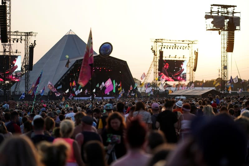 The sun sets behind the Pyramid stage during Glastonbury Festival in Somerset