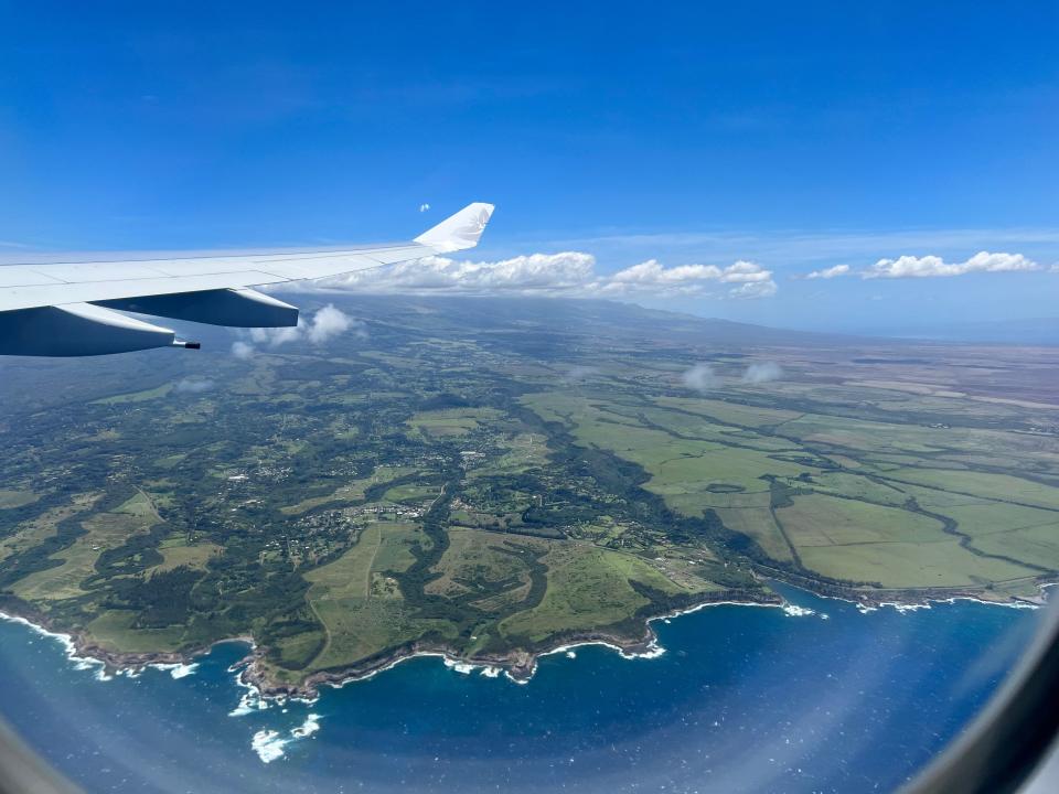airplane views of Maui - green grass and blue waters