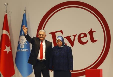 Turkish Prime Minister and leader of the ruling AK Party Binali Yildirim, accompanied by his wife Semiha, greets his supporters during a campaign meeting for the April 16 constitutional referendum, in Ankara, Turkey, February 25, 2017. REUTERS/Umit Bektas