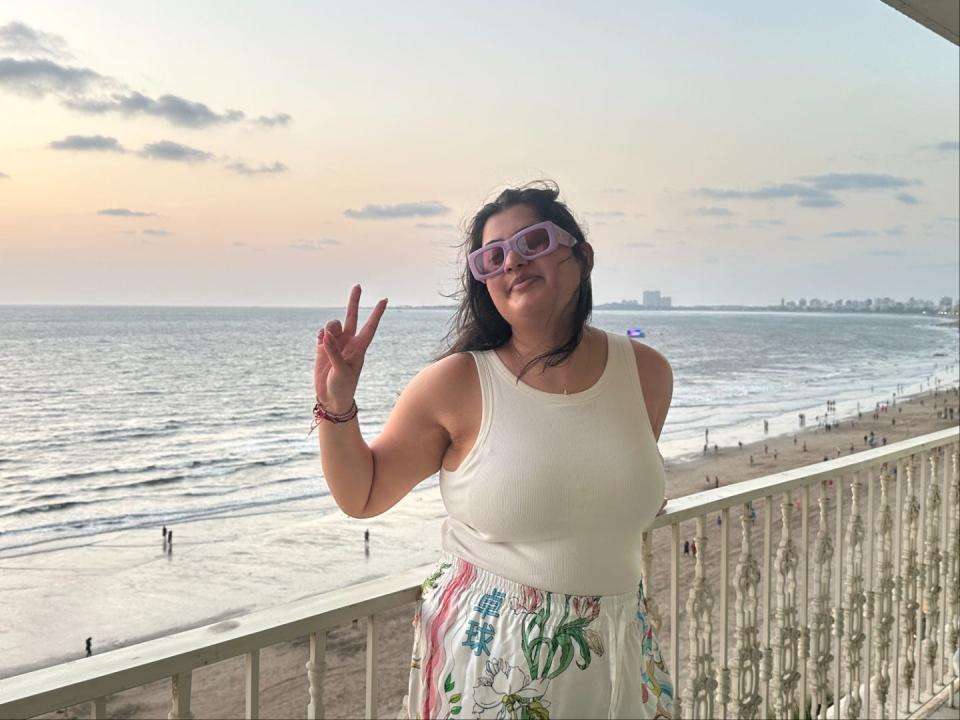 Business Insider's reporter on a balcony facing the beach in Mumbai, India.