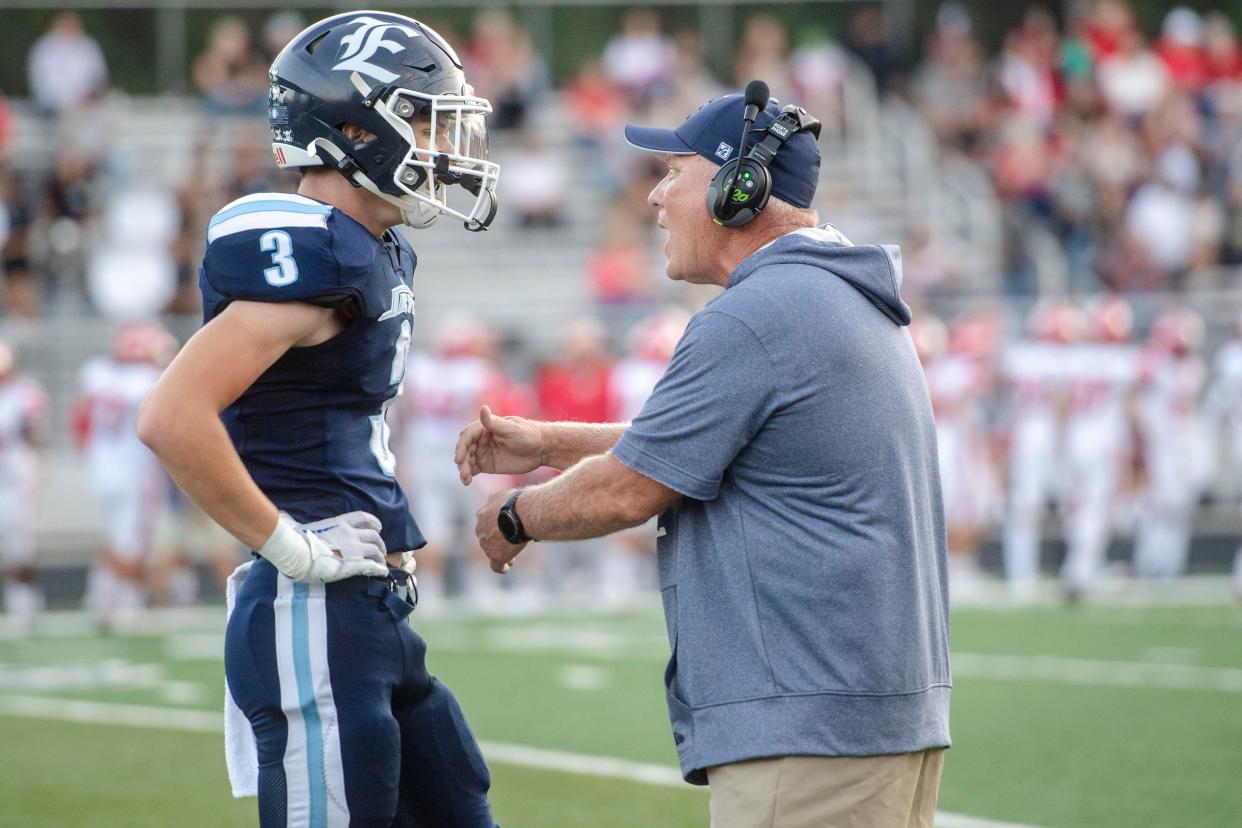 Enka head coach, Mike Sexton, talks to DJ Hullryde during the game against Erwin, September 15, 2023. Erwin won, 49-16.