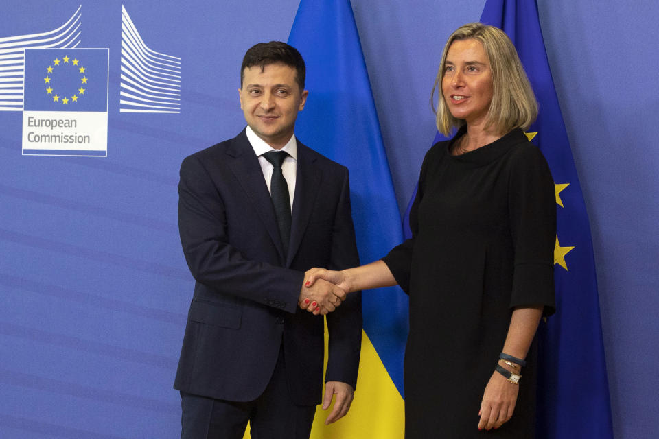 European Union foreign policy chief Federica Mogherini, right, shakes hands with Ukrainian President Volodymyr Zelenskiy prior to a meeting at EU headquarters in Brussels, Wednesday, June 5, 2019. (AP Photo/Virginia Mayo)