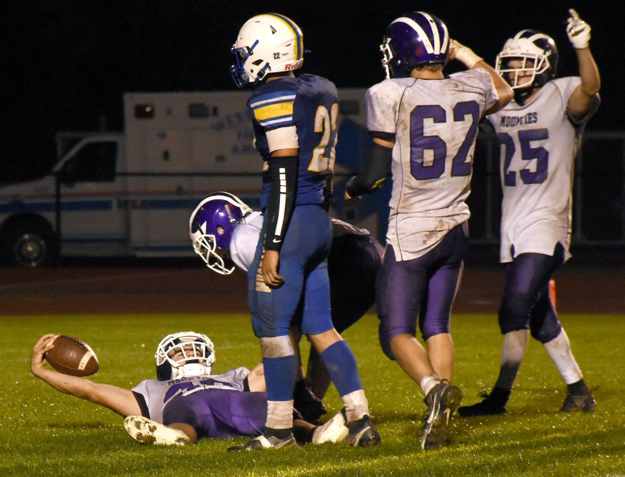 Little Falls Mountie Mason Rowley raises the ball in celebration after scoring the winning touchdown in overtime at Mt. Markham Oct. 8, 2021. The Mounties and Mustangs have played games decided by a total of 10 points in the last four season and are making the move from Class C football to Class D for the fall of 2022.