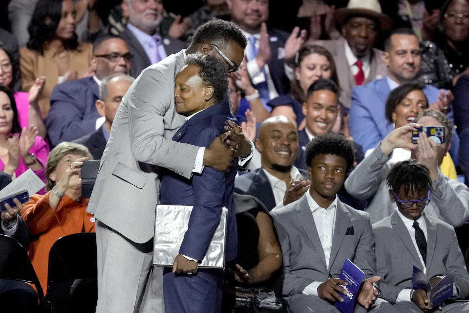 Chicago Mayor-elect Brandon Johnson hugs out-going Mayor Lori Lightfoot, during his inauguration as the city's 57 mayor Monday, May 15, 2023, in Chicago. (AP Photo/Charles Rex Arbogast)